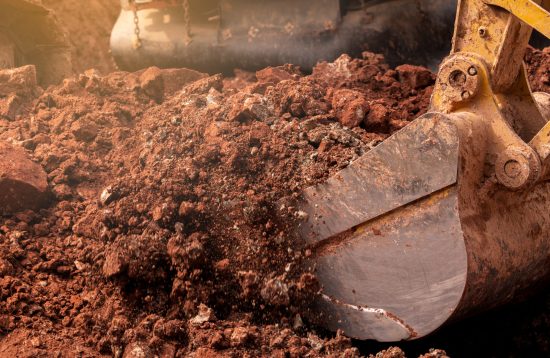 Closeup,Bucket,Of,Backhoe,Digging,The,Soil,At,Construction,Site.