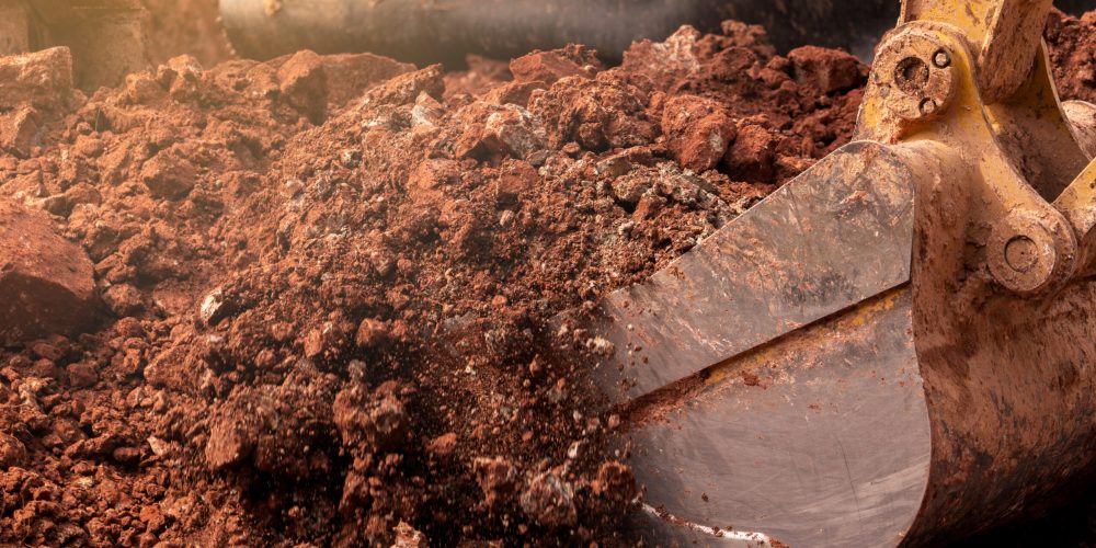 Closeup,Bucket,Of,Backhoe,Digging,The,Soil,At,Construction,Site.