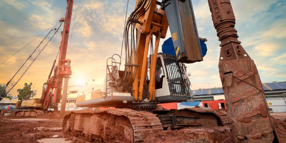 Hydraulic,Pile,Drilling,Machine,Worker,Digging,At,Industrial,Construction,Site.