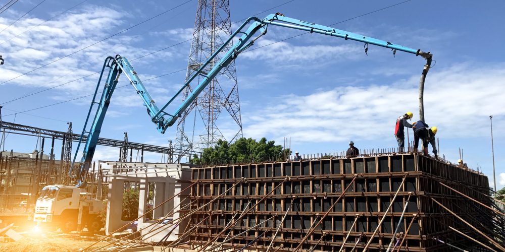 Construction,Building,Works,With,Automobile,Concrete,Pump,selective,Focus.two,Workers,Are