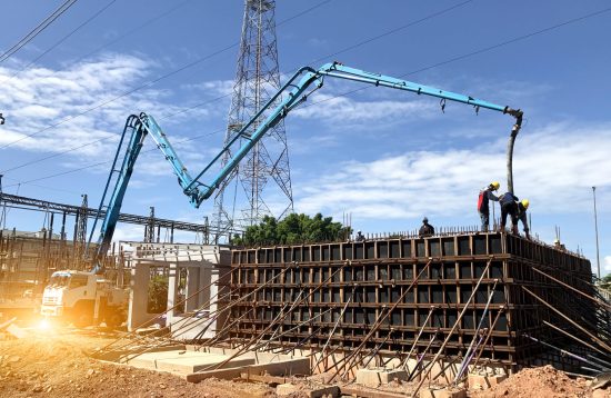 Construction,Building,Works,With,Automobile,Concrete,Pump,selective,Focus.two,Workers,Are